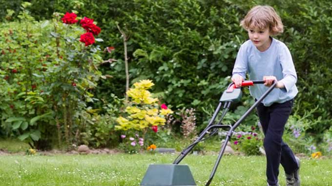 Child pushing lawnmower