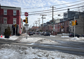 Philadelphia intersection with snow on road after a few days of snowfall