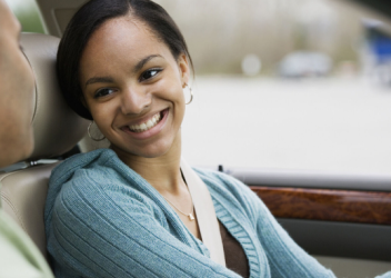Teen girl driver smiling at parent